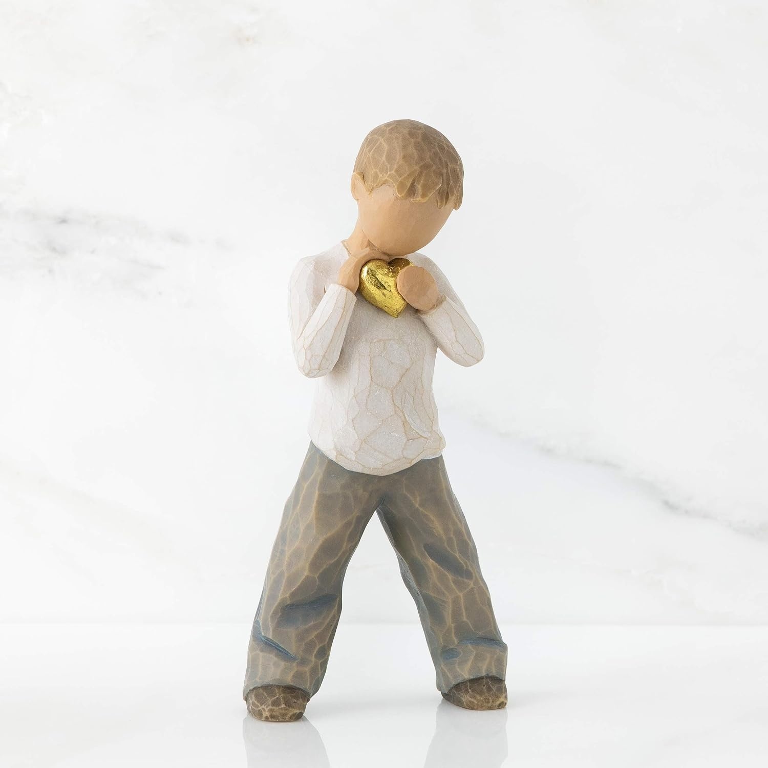 image:imageWillow Tree Heart of Gold Sculpted HandPainted Figure Holds GoldLeaf Heart to Chest Cream Shirt and Blue Jeans Love and Sympathy Gift Cast from a Susan Lordi Original Carving